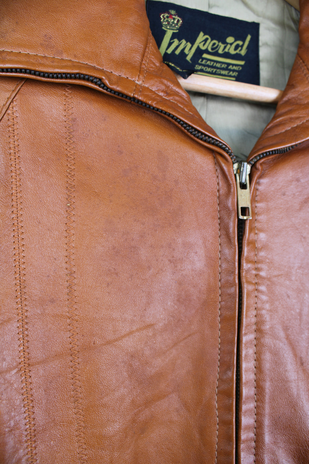 Vintage 1970's orange/tan zip through leather jacket, by Imperial. Features dagger collar, and drawstring waist 