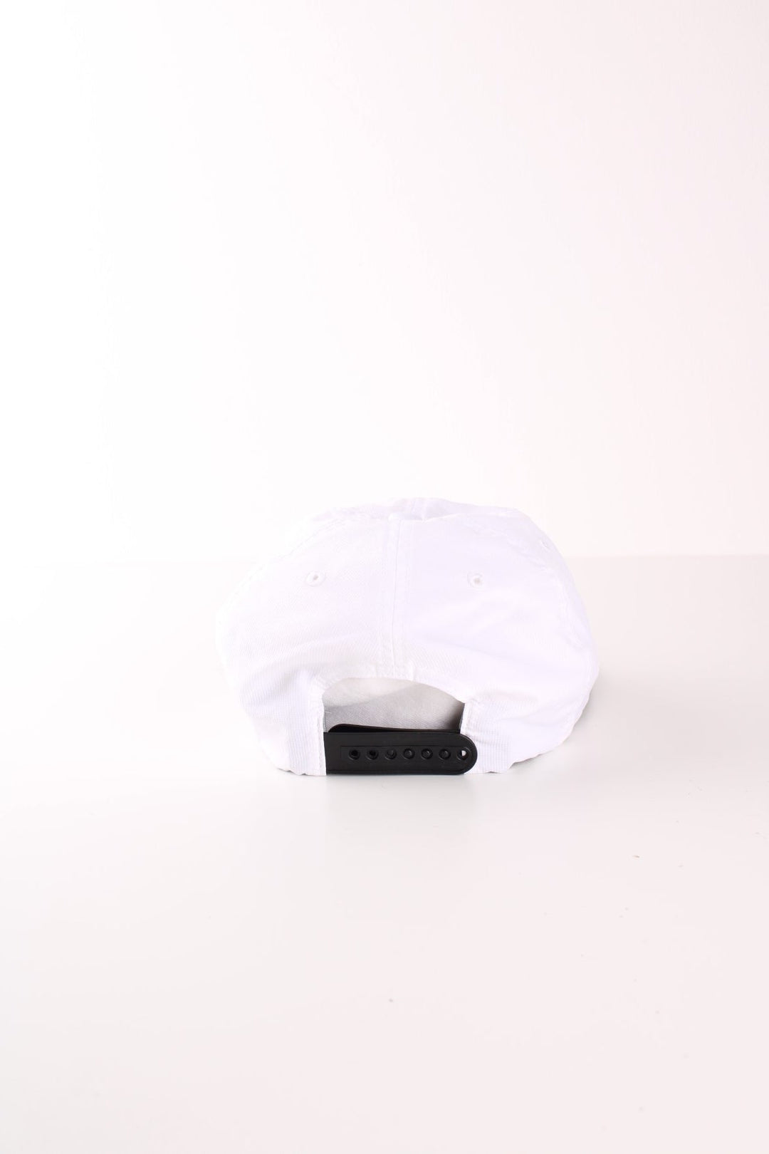 Adidas all white lightweight sporting cap with black embroidered logo on the front and snap adjustable strap