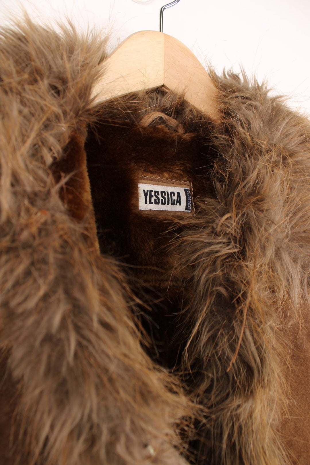 Y2K short brown afghan coat by Yessica with faux fur trim, two zipped pockets, and hook and eye closure.