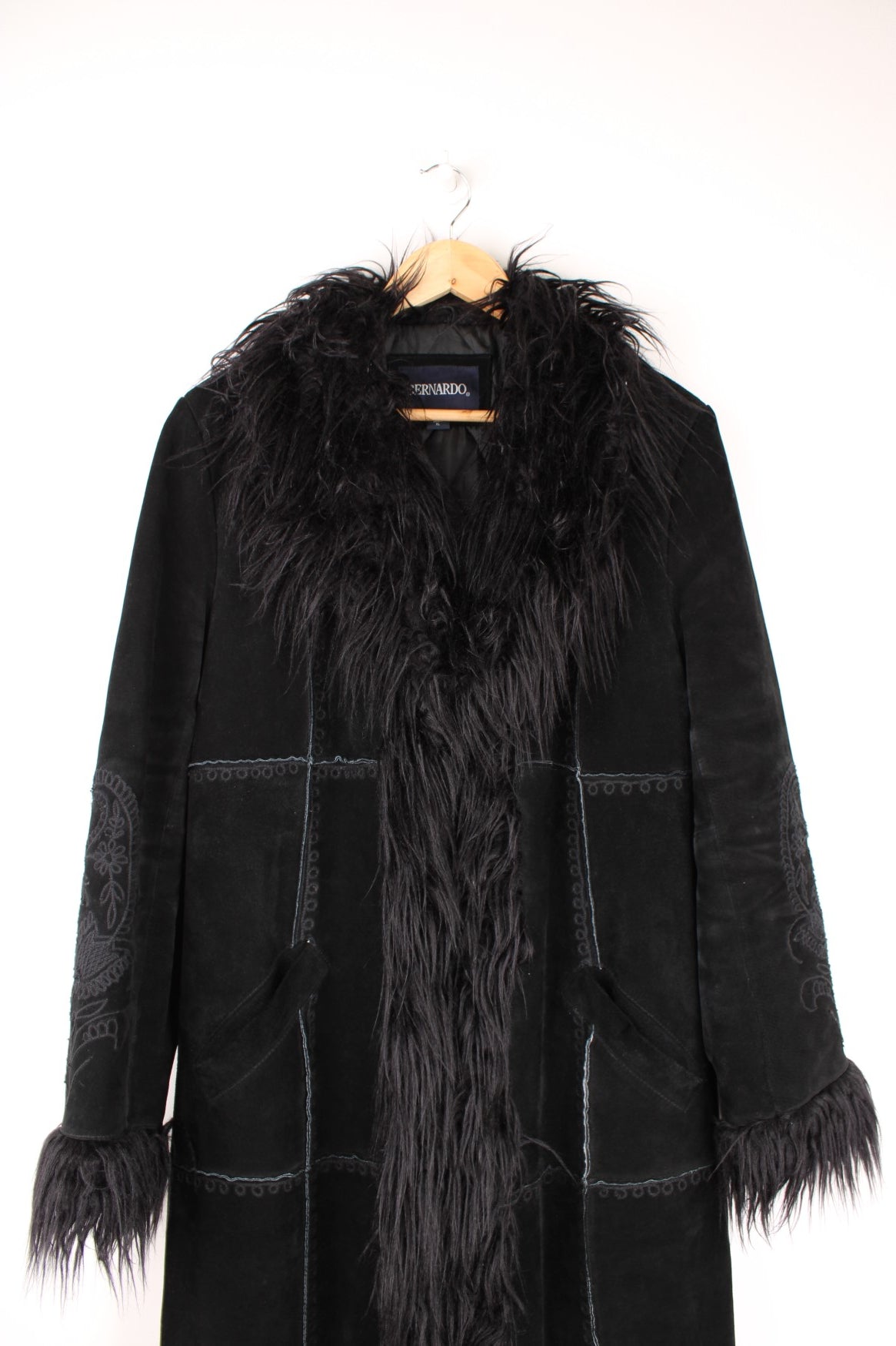 Y2K black suede afghan coat by Bernardo, with faux fur trim, embroidery on the back and sleeves, two side pockets, and hook and eye closure.  