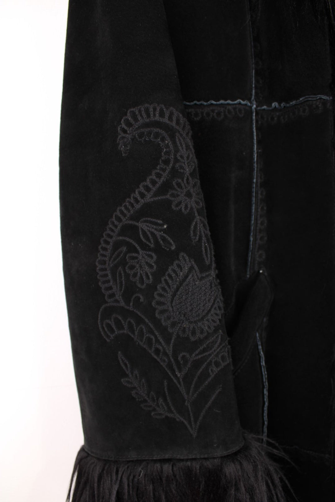 Y2K black suede afghan coat by Bernardo, with faux fur trim, embroidery on the back and sleeves, two side pockets, and hook and eye closure.  