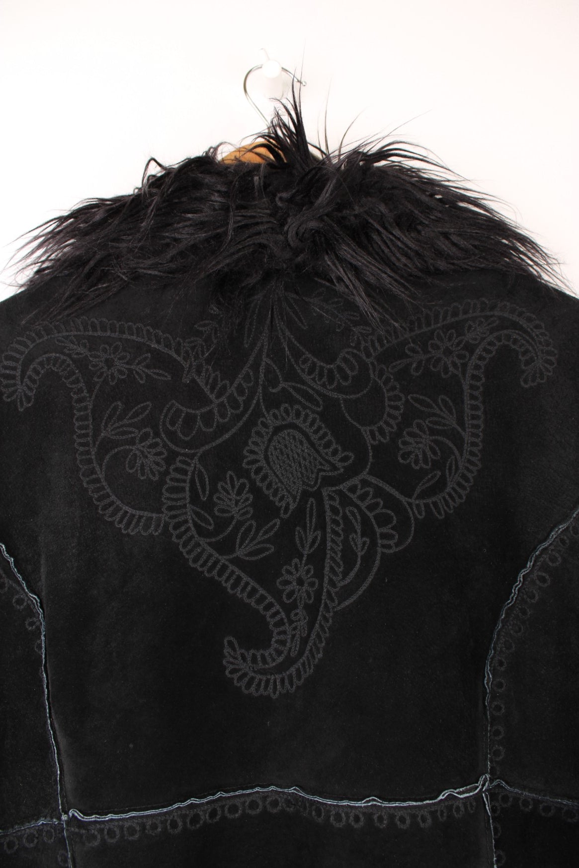 Y2K black suede afghan coat by Bernardo, with faux fur trim, embroidery on the back and sleeves, two side pockets, and hook and eye closure.  