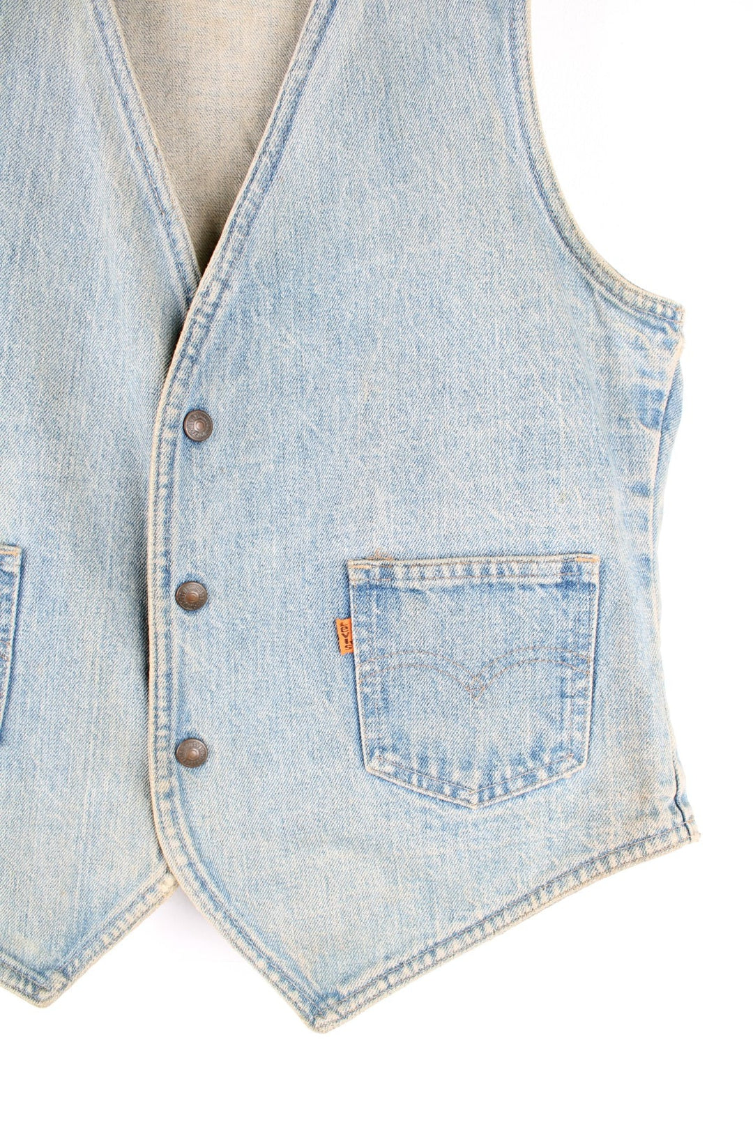 1970s orange tab Levi Strauss waistcoat in a light faded blue colourway, the waistcoat has two patch pockets on the front and metal press studs to close. 