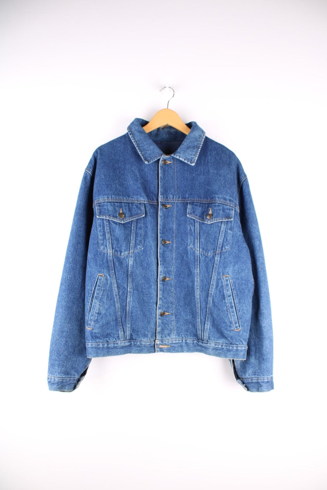 Vintage 1990s Armani Jeans denim jacket in a blue colourway. The jacket is reversible on one side is a traditional denim jacket with two breast pockets, and two jetted pockets. When reversed, the jacket becomes a bomber style, with nylon quilted sleeves, a denim collar and soft cotton panels with pouch pocket detail.  