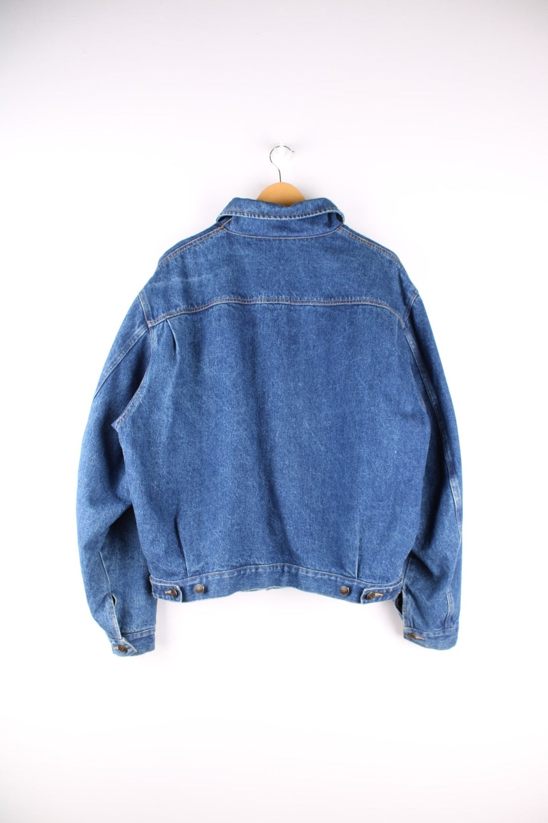 Vintage 1990s Armani Jeans denim jacket in a blue colourway. The jacket is reversible on one side is a traditional denim jacket with two breast pockets, and two jetted pockets. When reversed, the jacket becomes a bomber style, with nylon quilted sleeves, a denim collar and soft cotton panels with pouch pocket detail.  