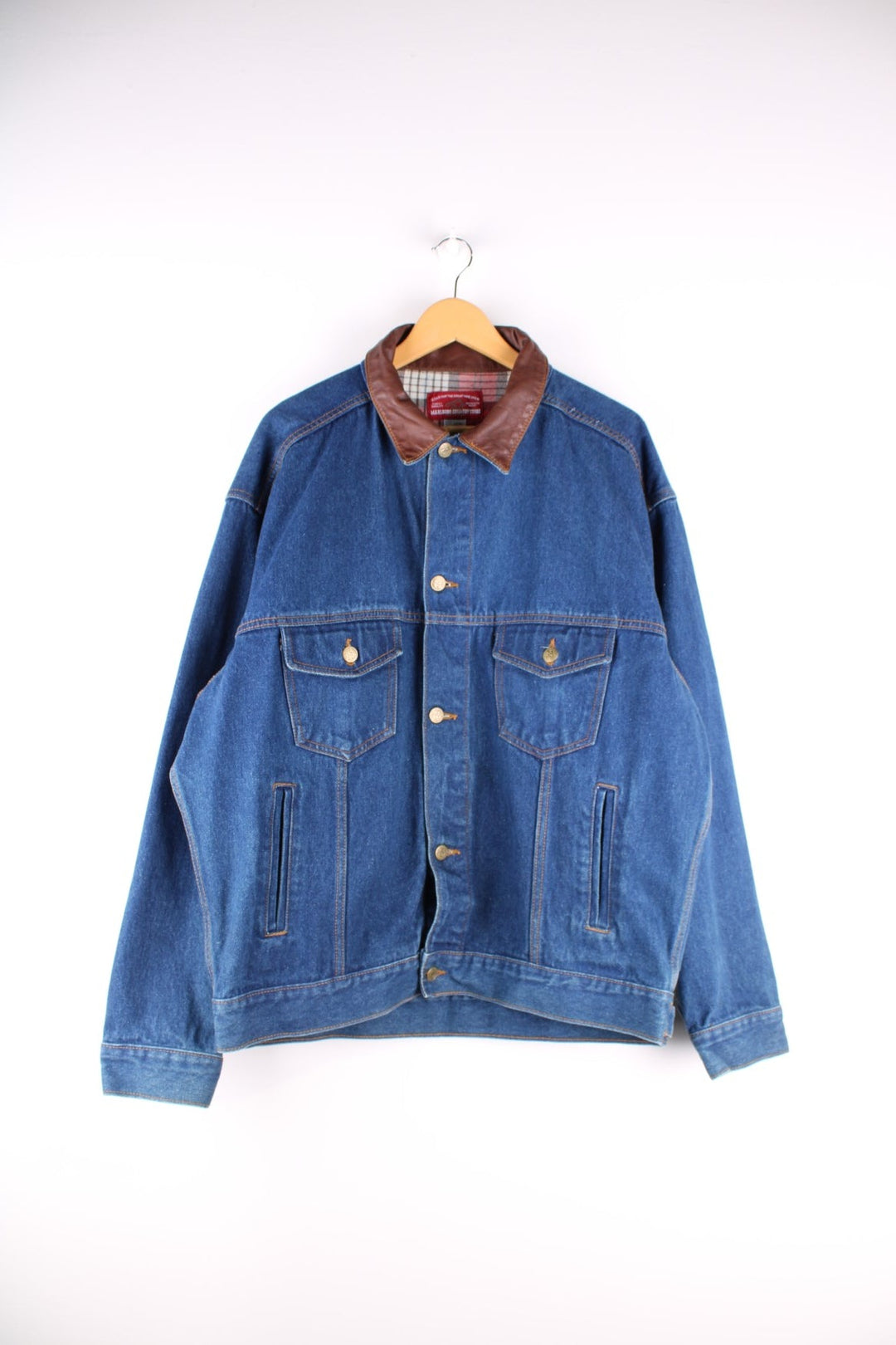 Vintage Marlboro Classics Country Store denim jacket in a indigo blue colourway,The jacket has a leather collar, has a checked cotton flannel yoke on the interior and multiple pockets. There is also a small leather patch sewn onto the back yoke. 