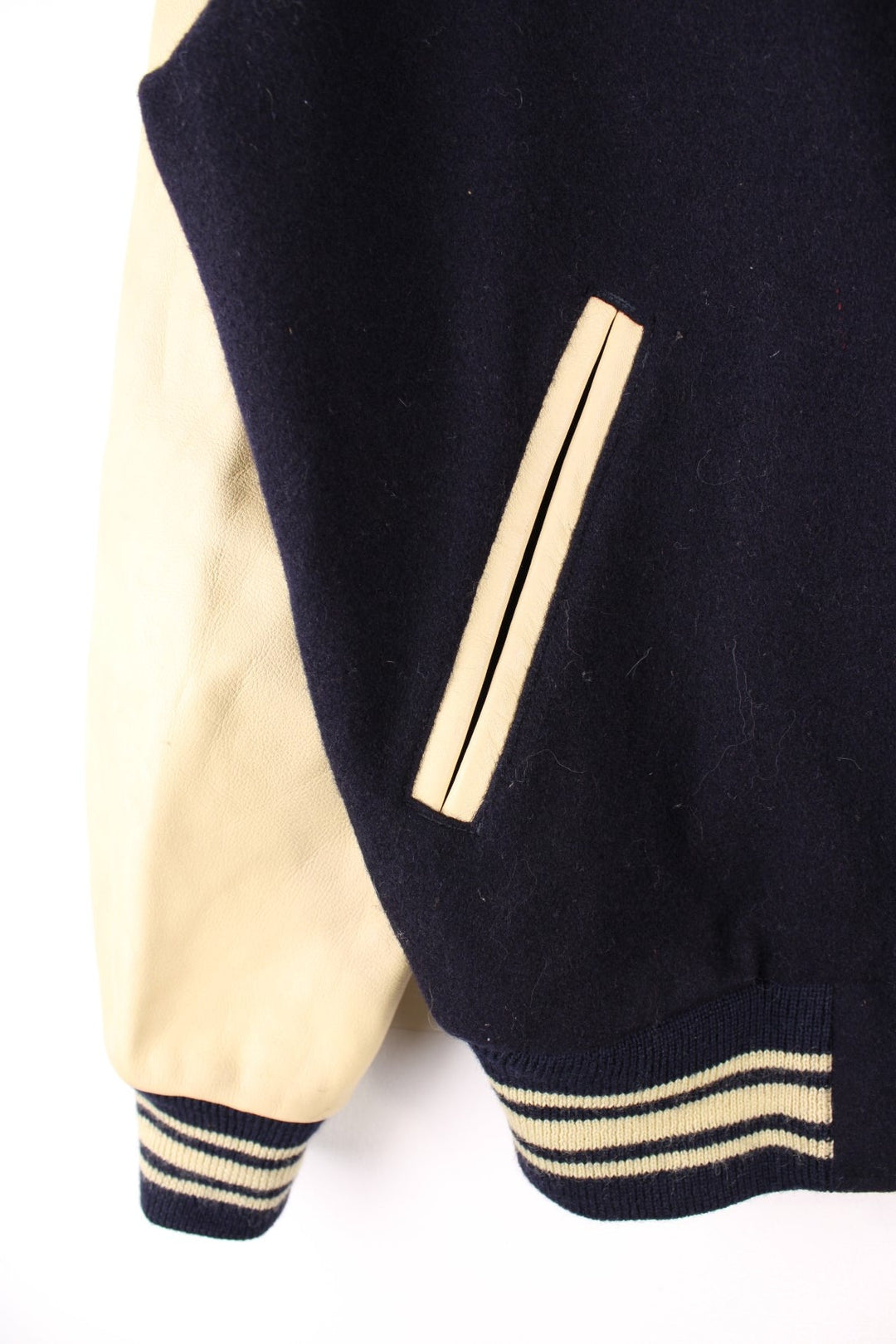 Vintage J Press Varsity Jacket in navy blue with cream sleeves and detail, The jacket has two jetted pockets, a J Press Patch on the front and elasticated cuffs.