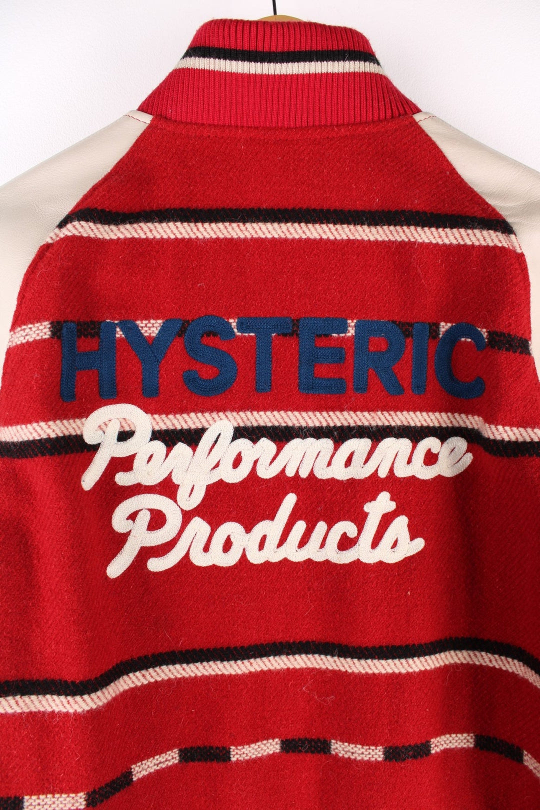 Vintage Hysteric Glamour varsity jacket in a red and cream colourway. The jacket has cream leather sleeves, press studs to close and jetted pockets on the front panels. The jacket is lined with a quilted fabric. and on the back there is a large chain stitched graphic reading 'Hysteric Performance Products'. Hysteric Glamour is a Japanese Streetwear brand, founded in 1984 by artist Nobuhiko Kitamura. 