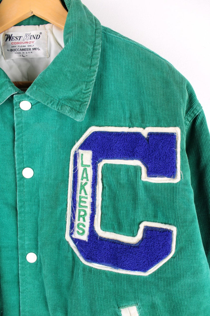 Vintage West Wind / Colchester Laker's corduroy varsity jacket in a green colourway. The jacket has a large Colchester Lakers tufted patch on the front panel, and Colchester is also embroidered on the back. There are jetted pockets, with a contrasting white cord trim and press studs to fasten. Made in the USA. 