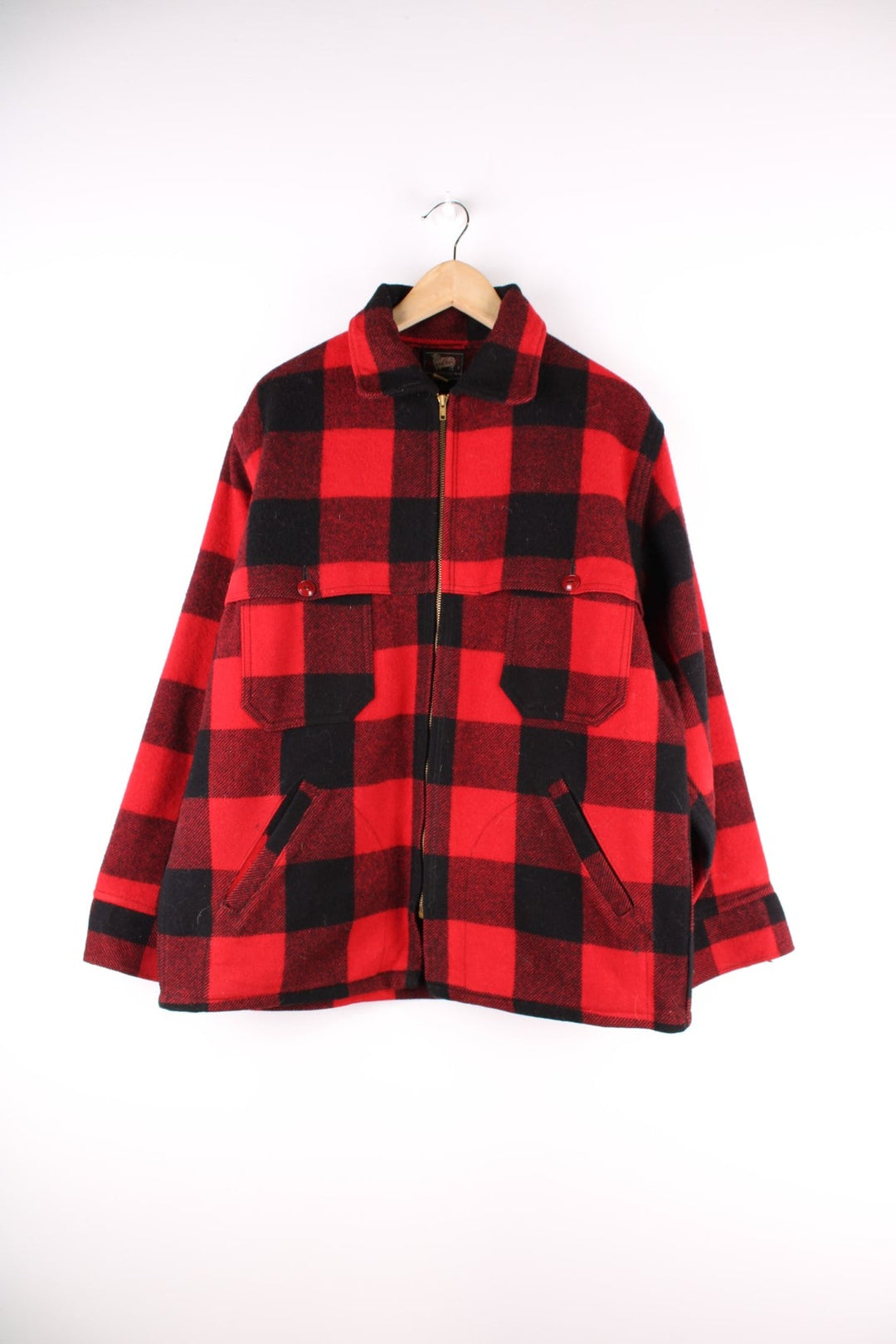 1950s Woolrich CPO Jacket in a red and black checked wool colourway. The jacket has two sets of pockets on the front panels, a talon zipper and the interior of of cuffs is lined with a black cotton fabric.