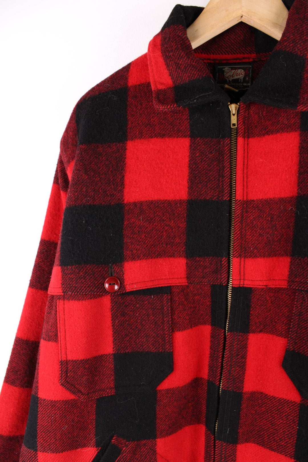 1950s Woolrich CPO Jacket in a red and black checked wool colourway. The jacket has two sets of pockets on the front panels, a talon zipper and the interior of of cuffs is lined with a black cotton fabric.