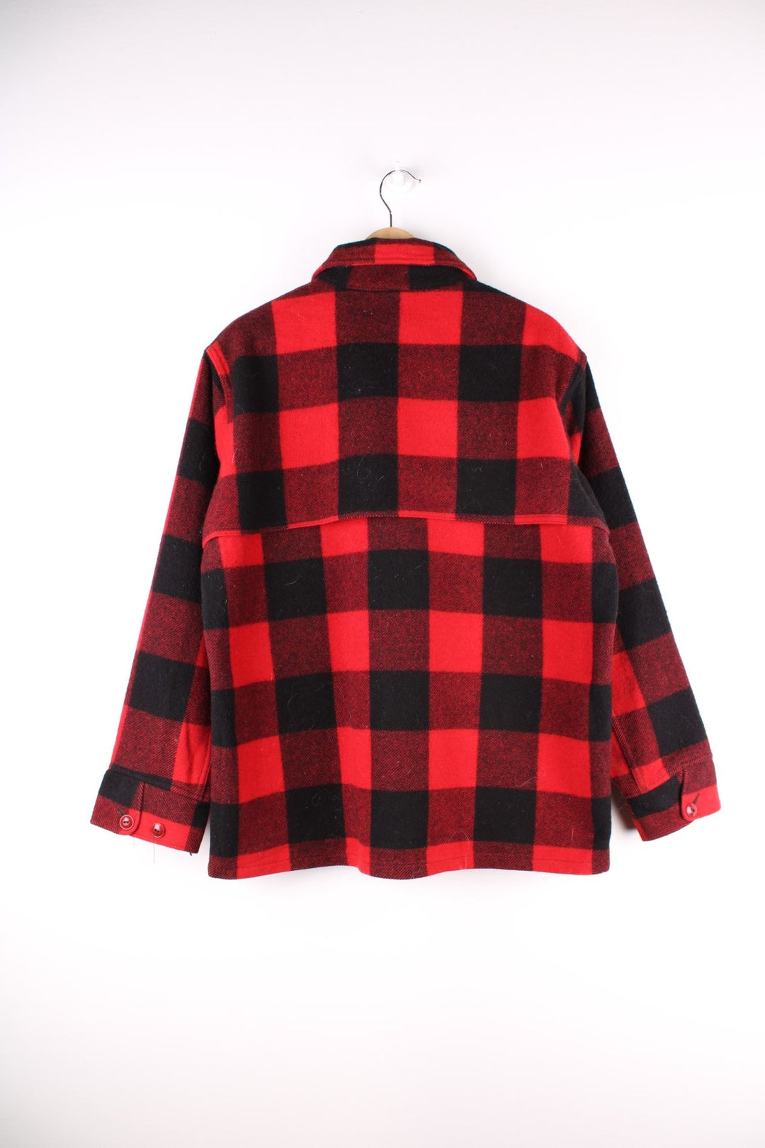 1950s Woolrich CPO Jacket in a red and black checked wool colourway. The jacket has two sets of pockets on the front panels, a talon zipper and the interior of of cuffs is lined with a black cotton fabric.