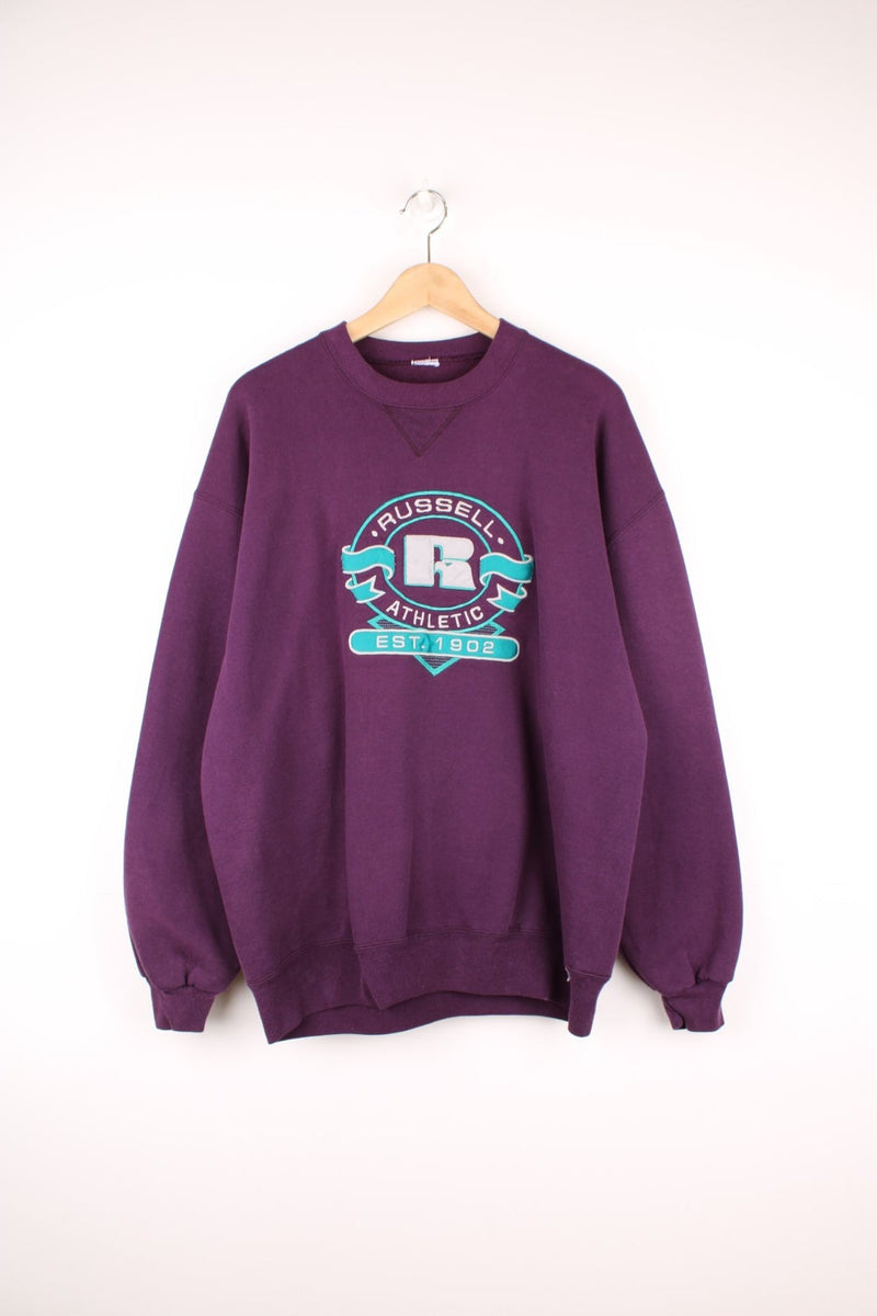 Vintage Russell Athletic sweatshirt in purple with blue logo graphic. 