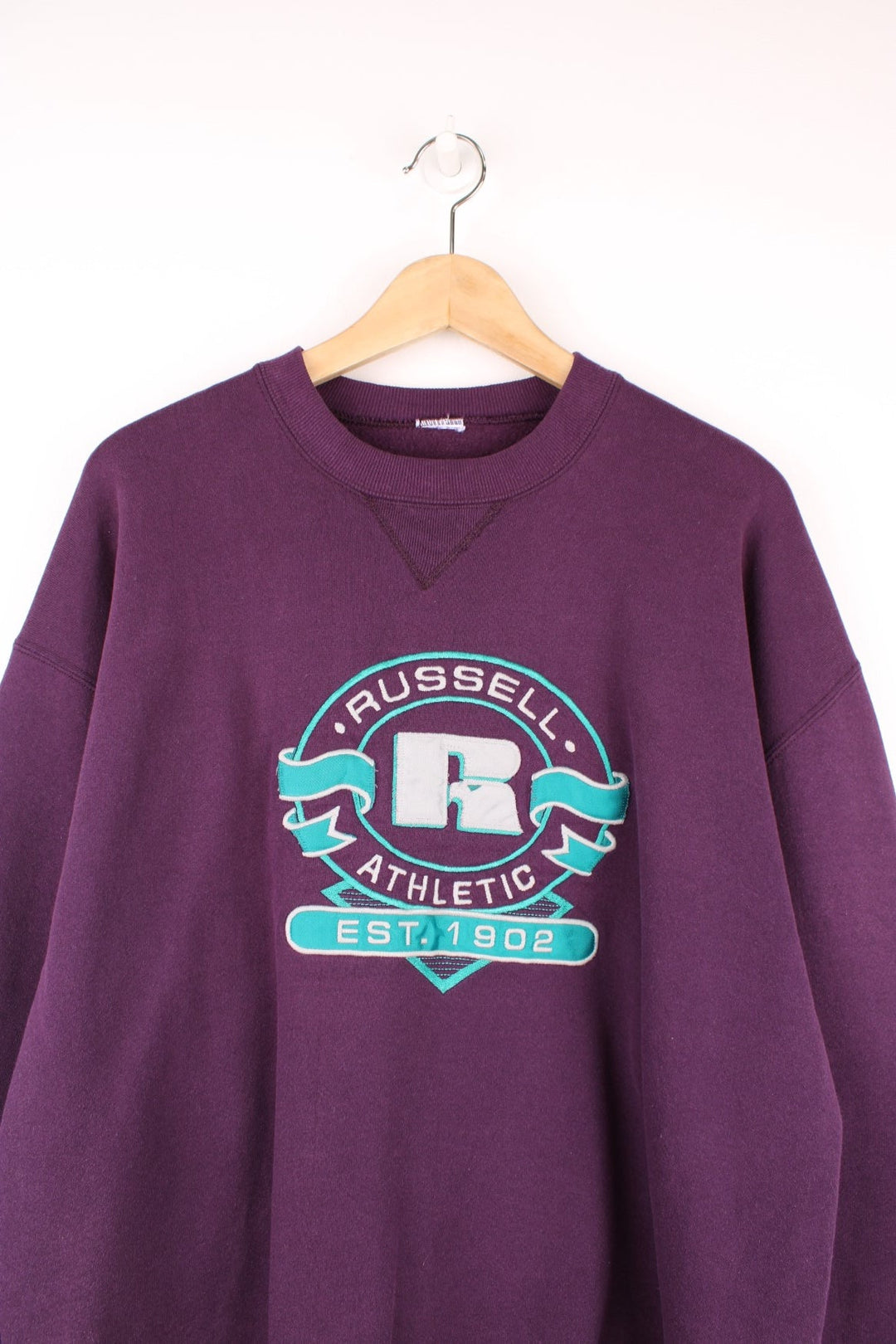 Vintage Russell Athletic sweatshirt in purple with blue logo graphic. 