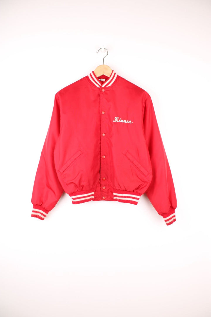 Vintage 1980's 'Birdie' red nylon varsity jacket, features large spell-out motif on the back 'Fox Lane Cross Country' in white. Also has personalised name on the chest and popper button fastening