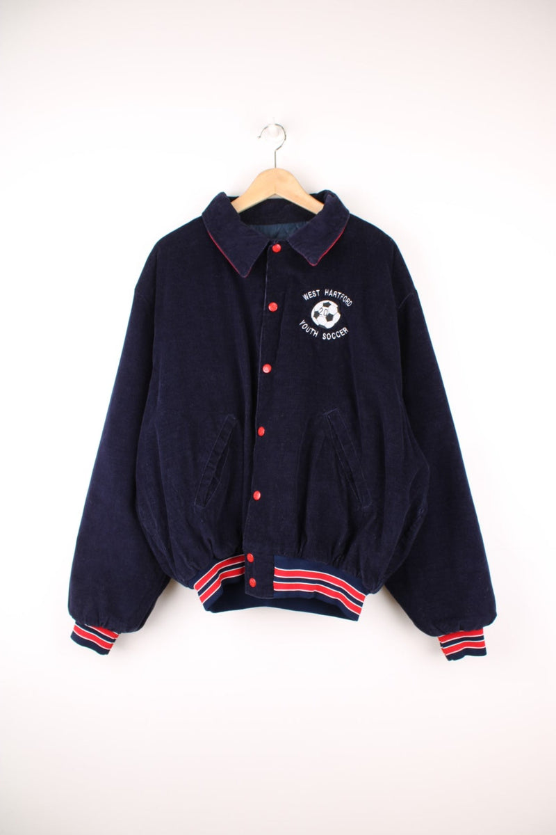 Vintage 90's navy blue corduroy varisty jacket by Birdie. Features embroidered 'Youth Soccer' badge on the chest, red popper buttons and quilted lining