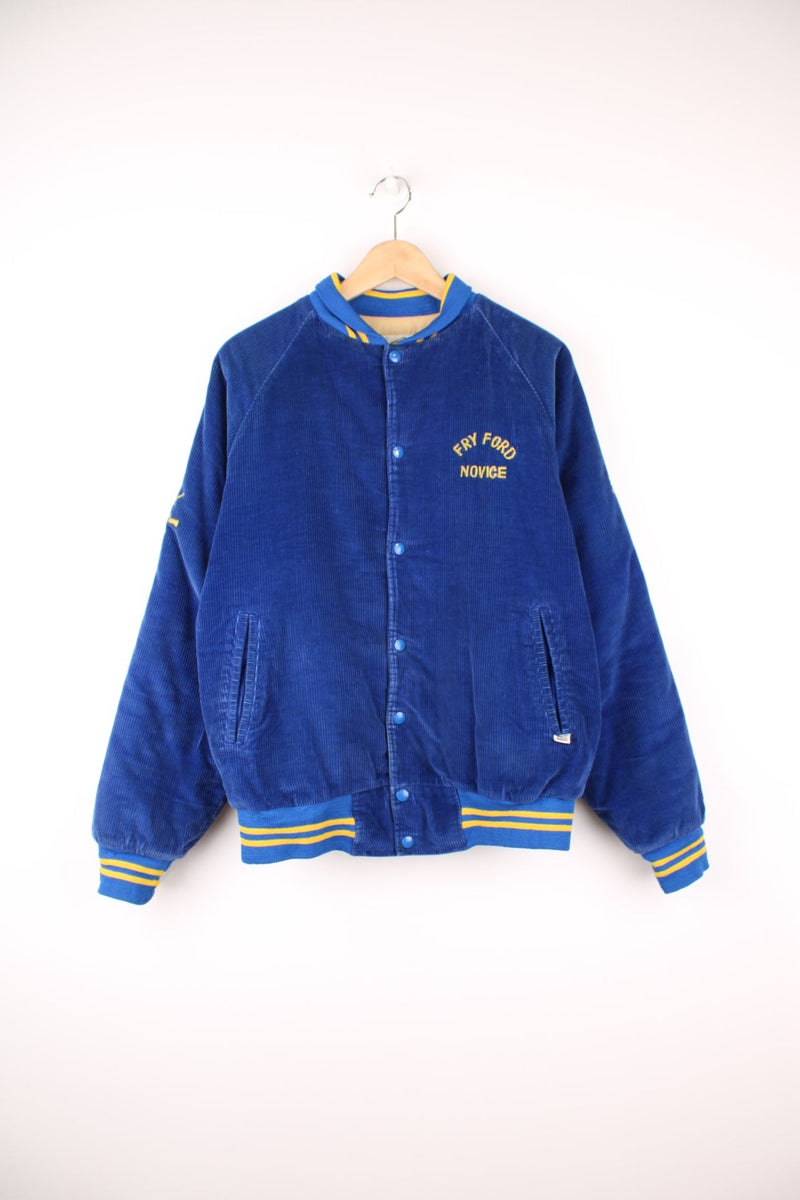 Vintage 90's 'Fry Ford' bright blue corduroy hockey themed varisty jacket. Features embroidered spell-out details on the sleeves, popper button fastenings and yellow quilted lining