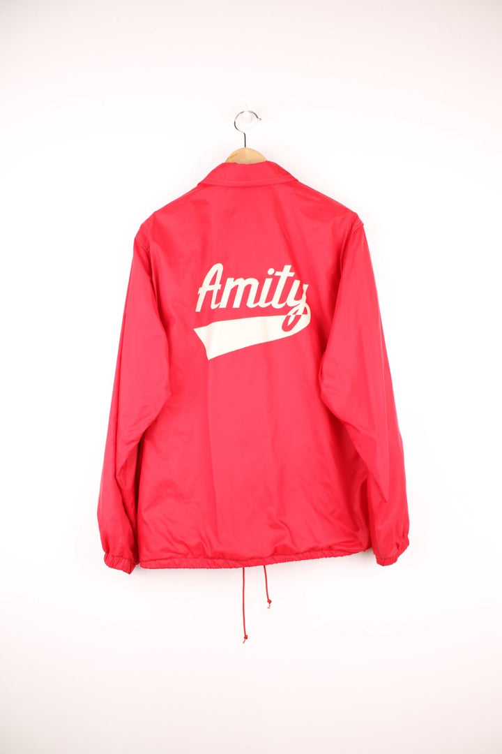 Vintage West Wind nylon coach jacket in red, features printed 'Amity Baseball' motif on the chest and back. 