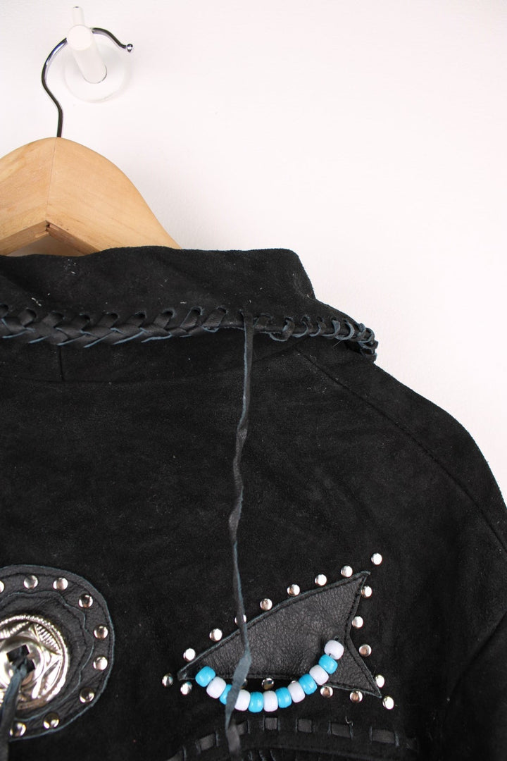 Sema Leathers Western Beaded Fringe Jacket in a black colourway, button up with side pockets, tassels throughout, and has beaded patterns on the front and back. 