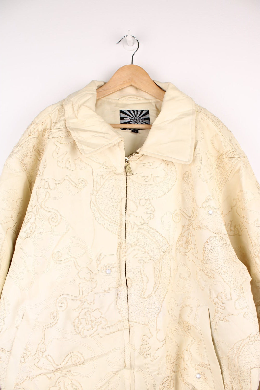 90's Y2K BlueZ Dragon Leather Jacket in a cream colourway, zip up with side pockets, big collar, and has embroidered dragons all over. 