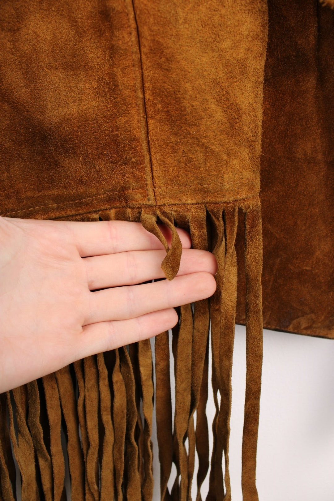 70's Suede Western Fringe Jacket in a brown colourway, button up with double chest pockets, dagger collar, and has tassels all around. 