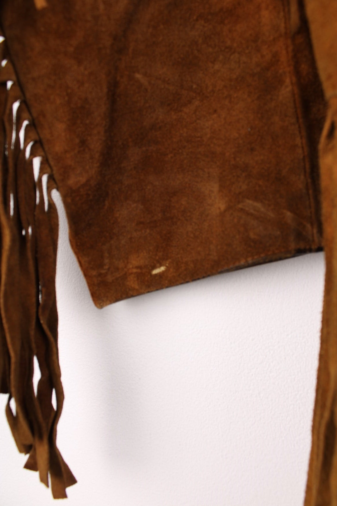 70's Suede Western Fringe Jacket in a brown colourway, button up with double chest pockets, dagger collar, and has tassels all around. 