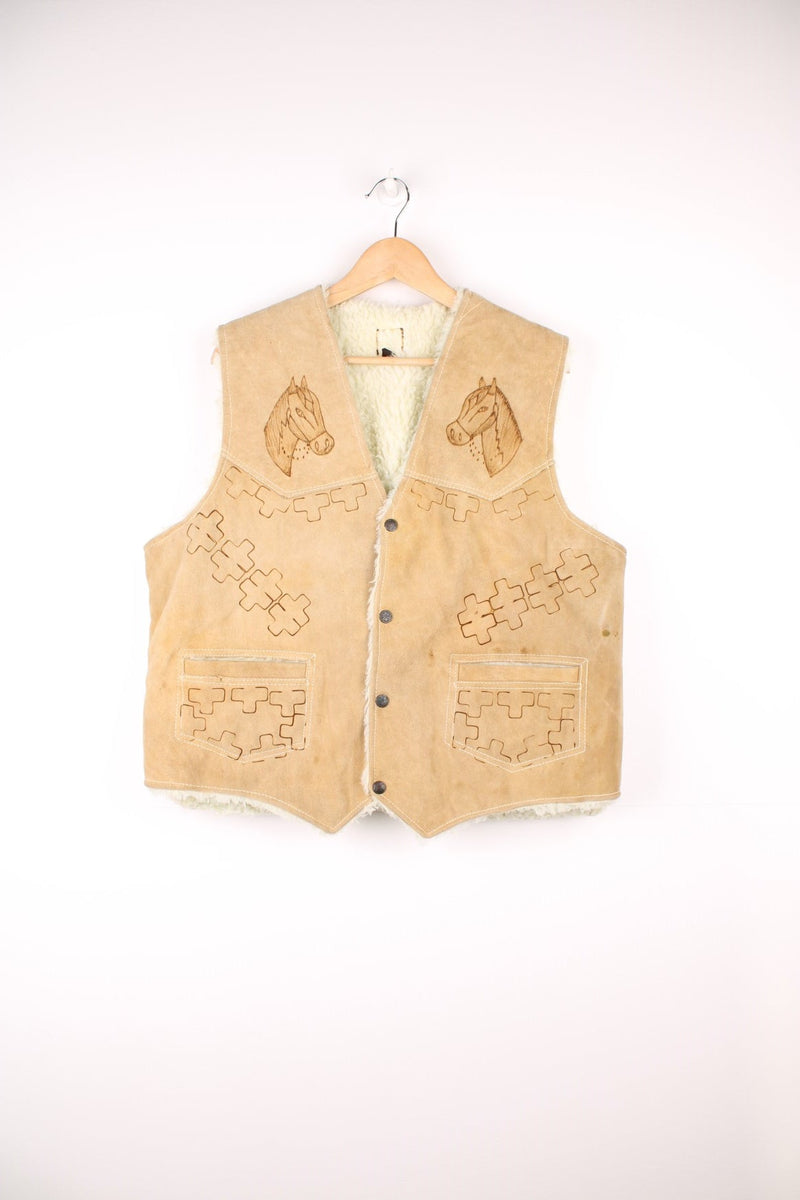 Western Suede Gilet in a tanned colourway with a white sherpa lining, button up with side pockets and has horses and western patterns burned into the garment.