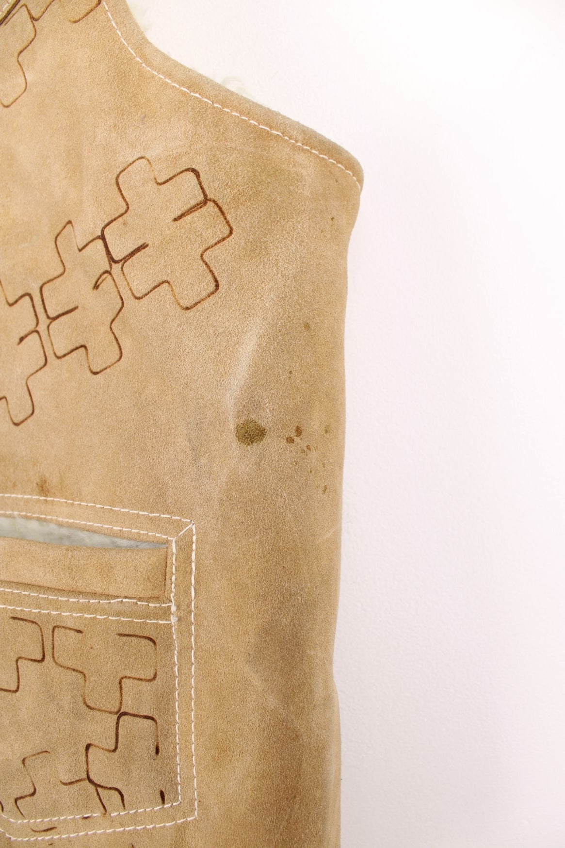 Western Suede Gilet in a tanned colourway with a white sherpa lining, button up with side pockets and has horses and western patterns burned into the garment.