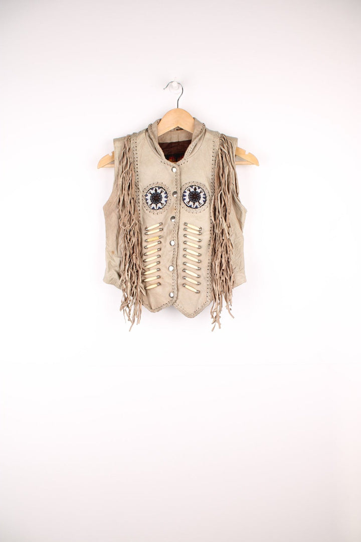 Vintage Native Leather Gilet by 'Hot Leathers' in a tanned colourway, button up, has bones and beades embroiderd on the front alongside the tassels on either side. 