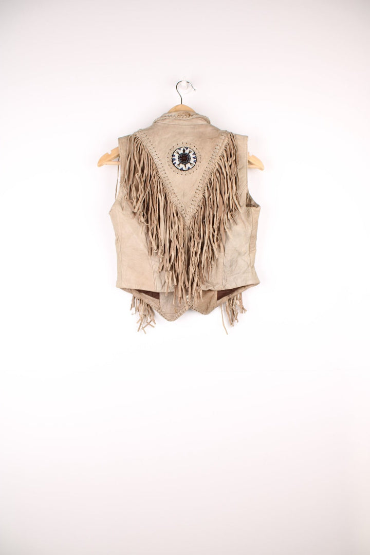 Vintage Native Leather Gilet by 'Hot Leathers' in a tanned colourway, button up, has bones and beades embroiderd on the front alongside the tassels on either side. 