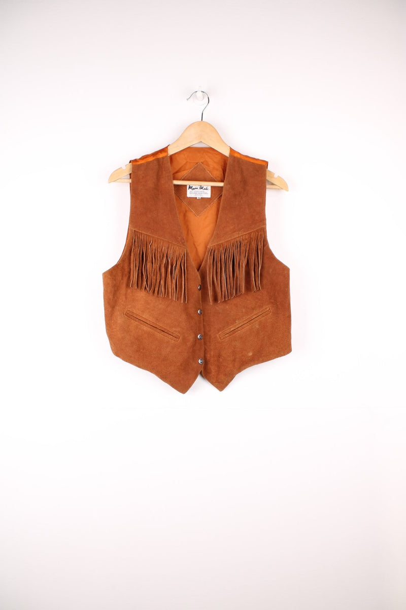 Mona Mode Western Fringe Gilet in a brown colourway, button up with side pockets, and has tassels on the front. 