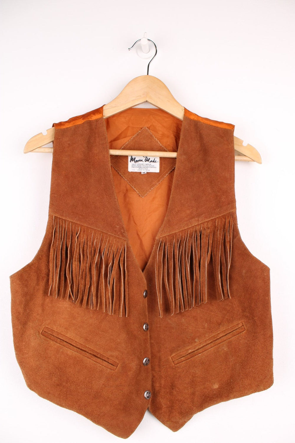 Mona Mode Western Fringe Gilet in a brown colourway, button up with side pockets, and has tassels on the front. 