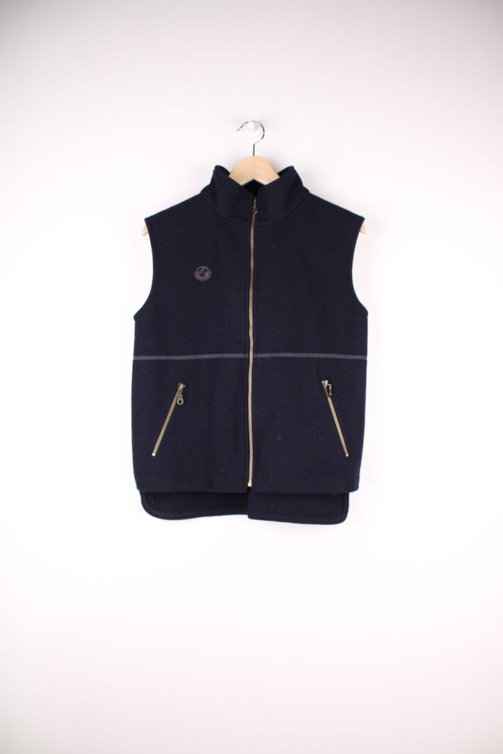 Swanndri Woolen Fleece Gilet in a navy blue colourway, zip up with side pockets, cross stitching going across the front and has the logo embroidered on the front. 