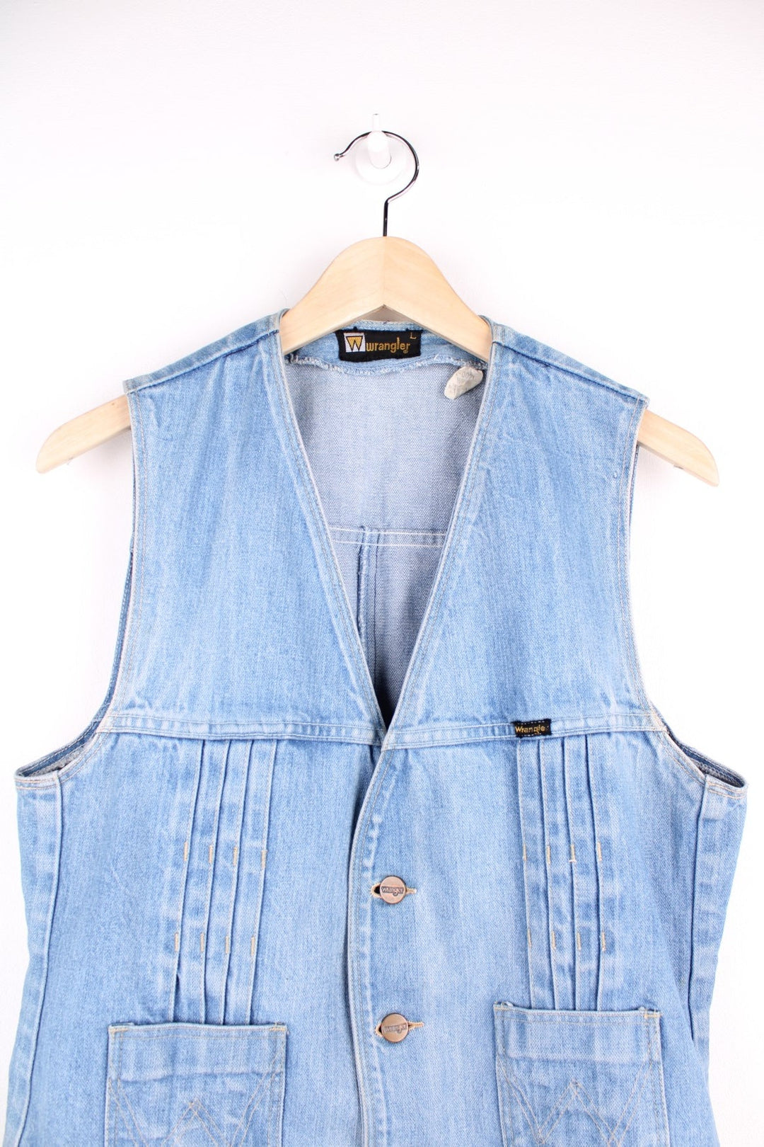 70s Wrangler light wash denim vest with pleats, two pockets, and button closure. 