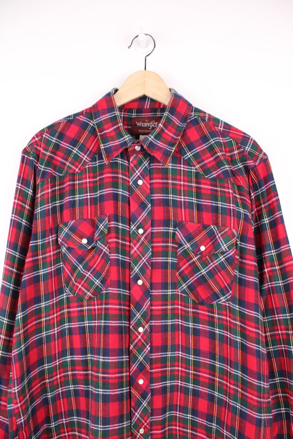 Wrangler shirt in red, green, and blue check with Western style yoke, pearl-effect snap closure and double flapped pockets.