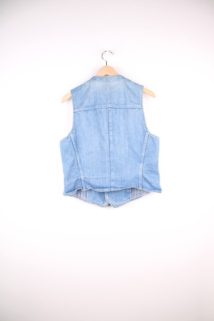 70s Wrangler light wash denim vest with pleats, two pockets, and button closure. 