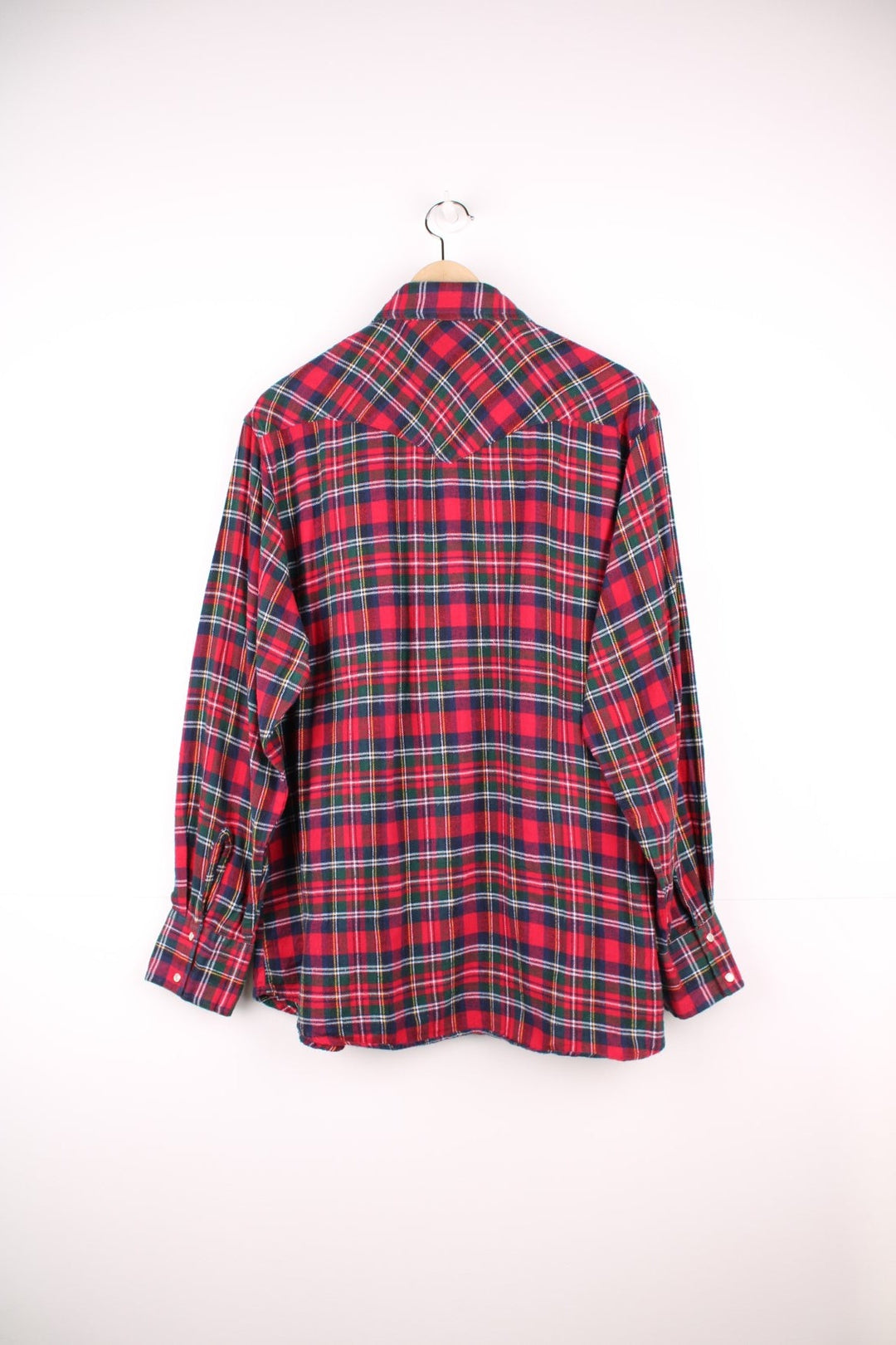 Wrangler shirt in red, green, and blue check with Western style yoke, pearl-effect snap closure and double flapped pockets.