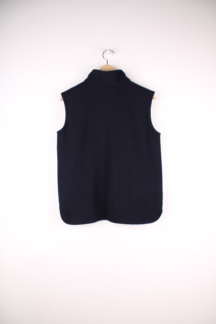 Swanndri Woolen Fleece Gilet in a navy blue colourway, zip up with side pockets, cross stitching going across the front and has the logo embroidered on the front. 