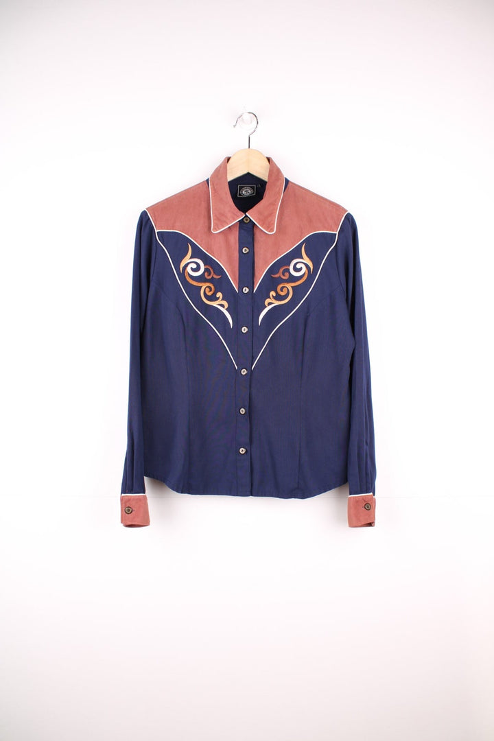 Navy blue western shirt by Silver Dollar with a brown contrast yoke and cuffs, white piping and embroidery on the front and back. 