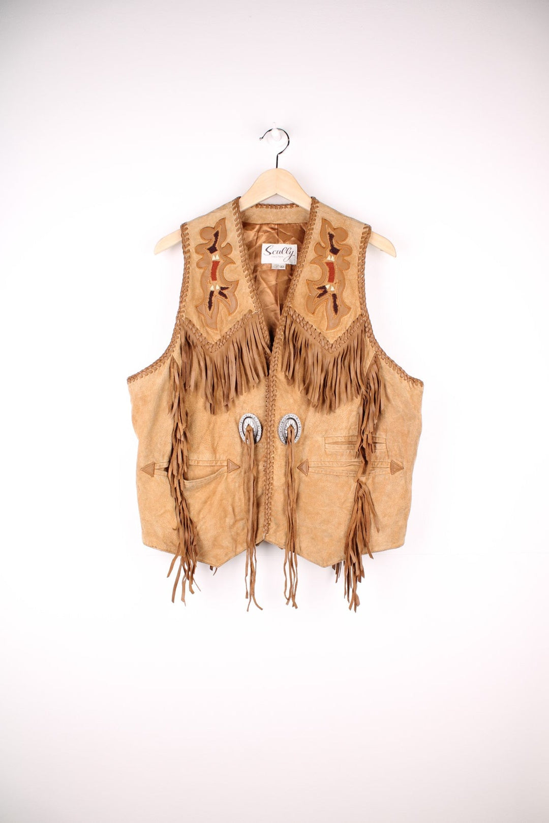 Vintage Scully Western Leather Fringe Waistcoat in a tanned brown colourway, has multiple pockets, embroidered bead native patterns, and has fringe tassels throughout.