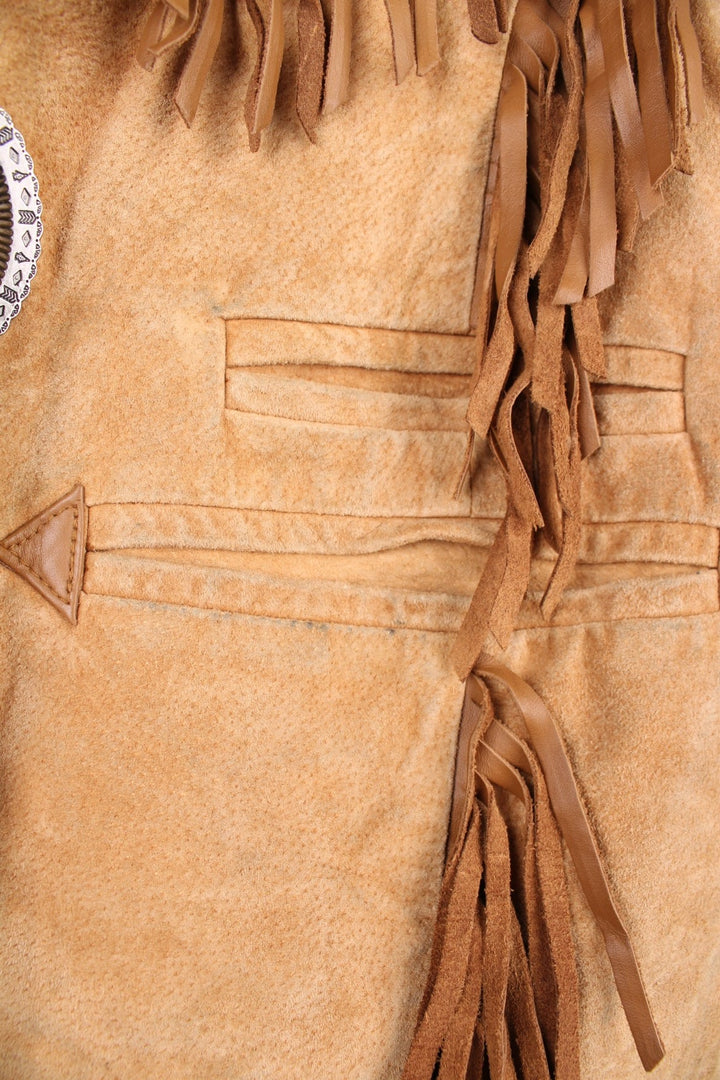 Vintage Scully Western Leather Fringe Waistcoat in a tanned brown colourway, has multiple pockets, embroidered bead native patterns, and has fringe tassels throughout.