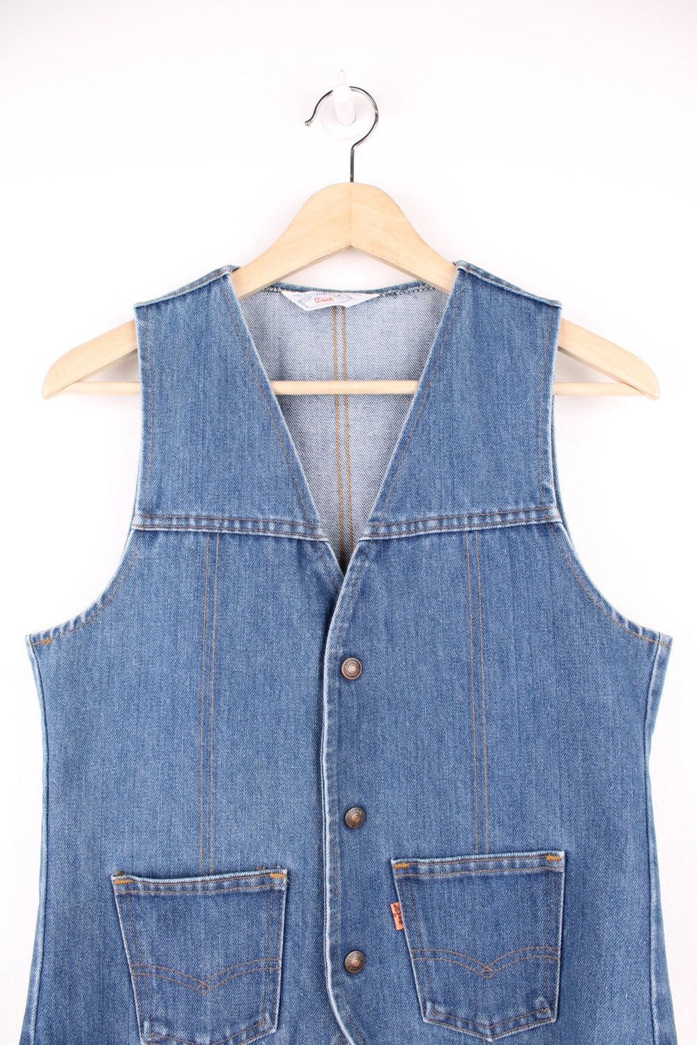 Orange tab Levi's blue denim vest with two patch pockets and button closure.  