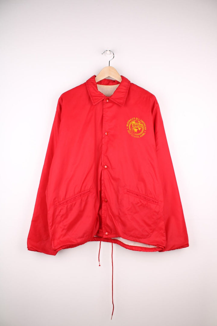 70s/80s McDonald's All-American High School Band coach jacket made by Empire Sporting Goods NY, with snap closure, two pockets, and a waist drawstring. 