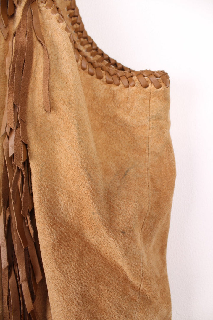 Vintage Scully Western Leather Fringe Waistcoat in a tanned brown colourway, has multiple pockets, embroidered bead native patterns, and has fringe tassels throughout.