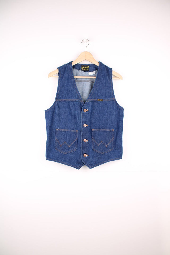 Wrangler Made in the USA 'No Fault' blue denim vest with button closure and two 'W' embroidered patch pockets. 