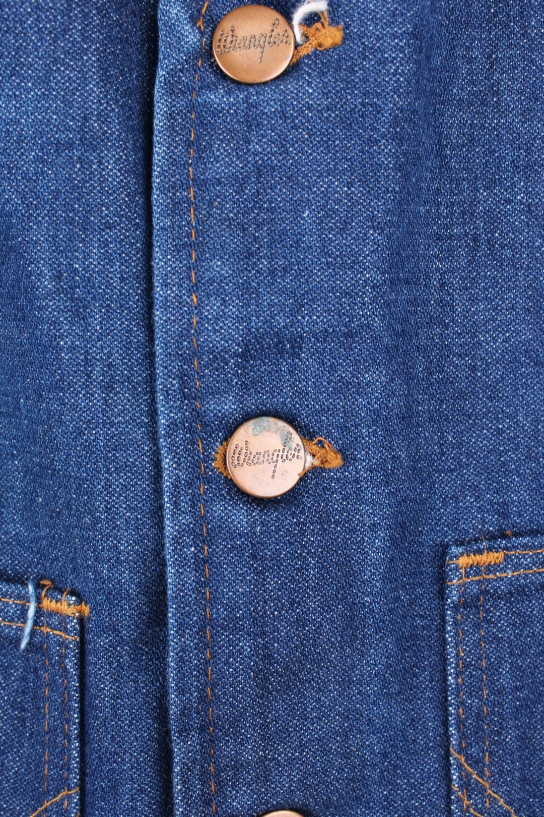 Wrangler Made in the USA 'No Fault' blue denim vest with button closure and two 'W' embroidered patch pockets. 