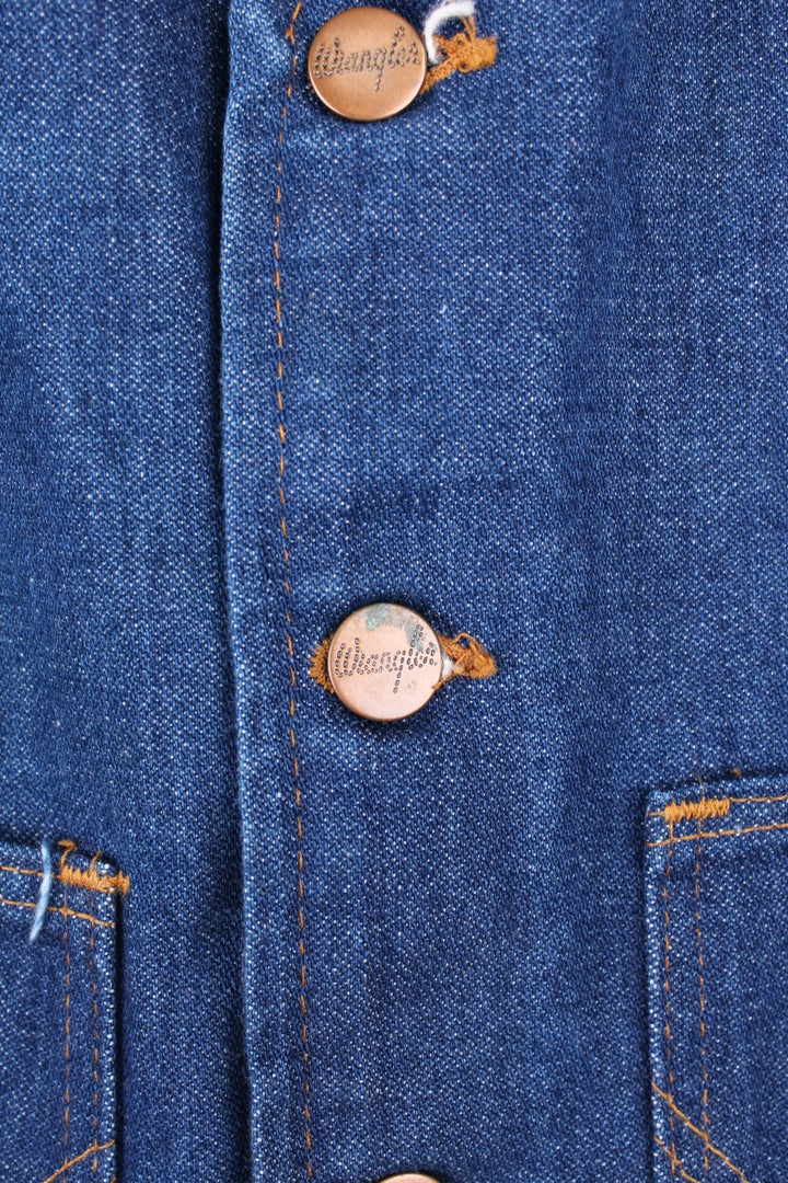 Wrangler Made in the USA 'No Fault' blue denim vest with button closure and two 'W' embroidered patch pockets. 