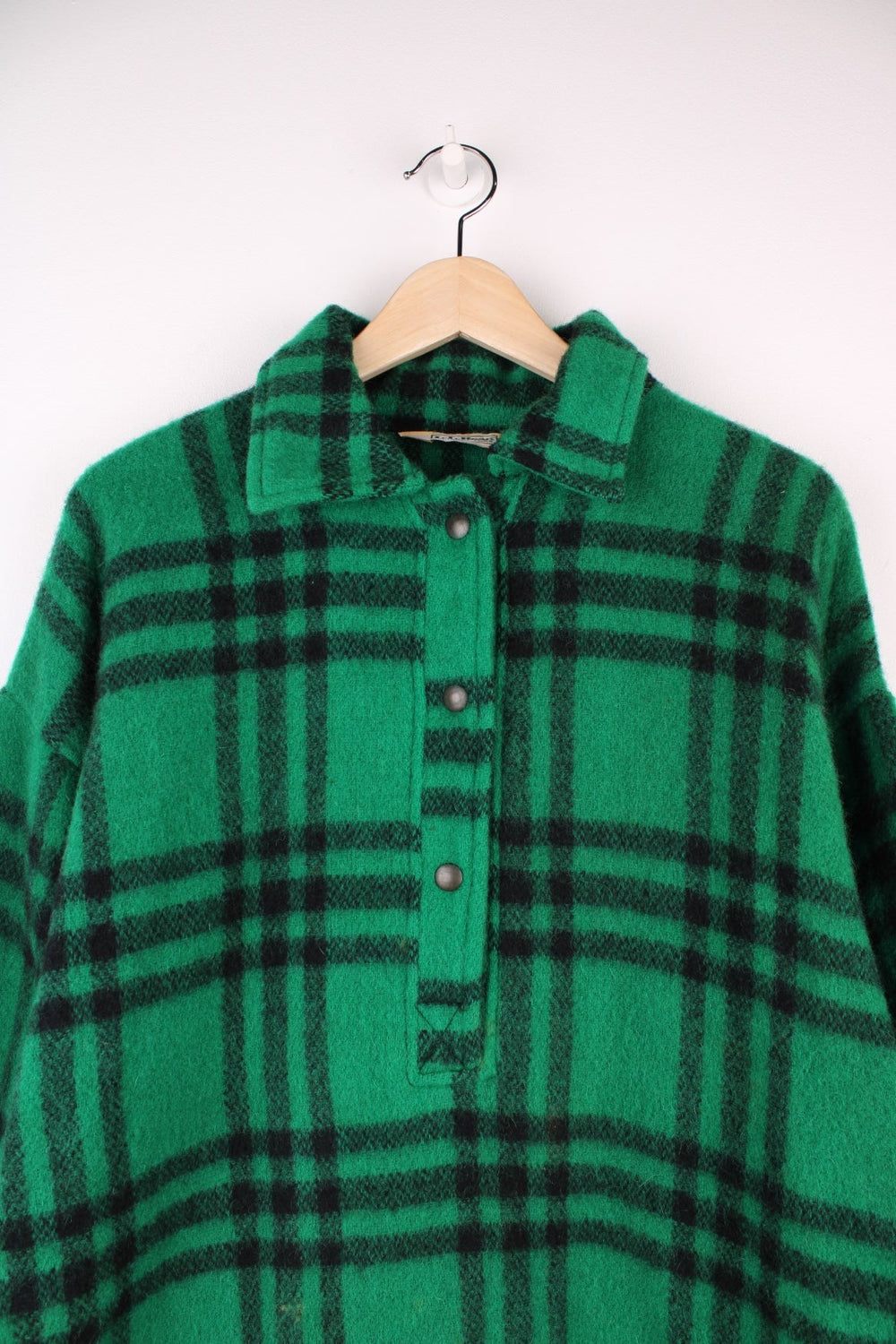 L.L. Bean Plaid Pullover Sweater in a green and black colourway, half button up with a collar, and has a adjustable hem. 