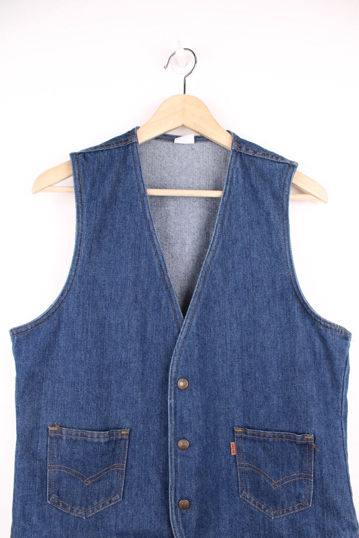 Orange tab Levi's blue denim vest with two patch pockets and button closure.  