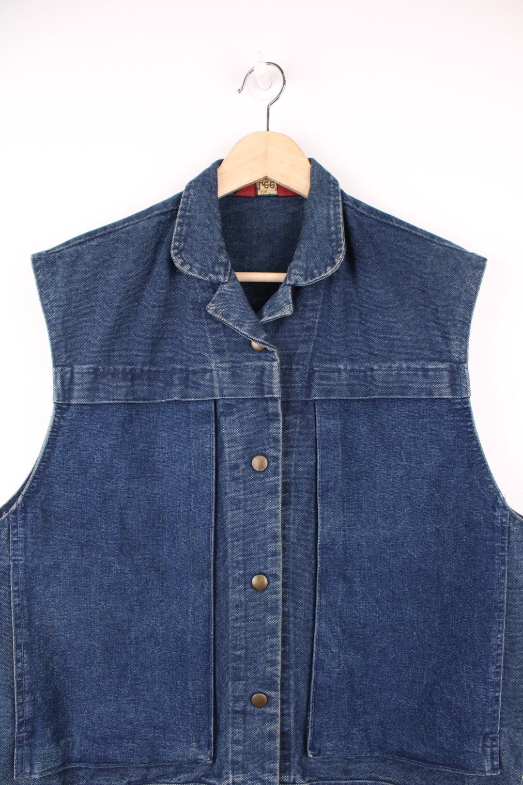 Ms. Lee collared blue denim vest with button closure and double side pockets. 